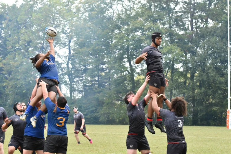 group of rugby players playing in the middle of a game