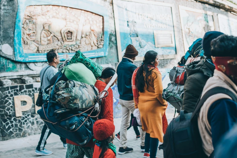 a group of people standing around outside in the street