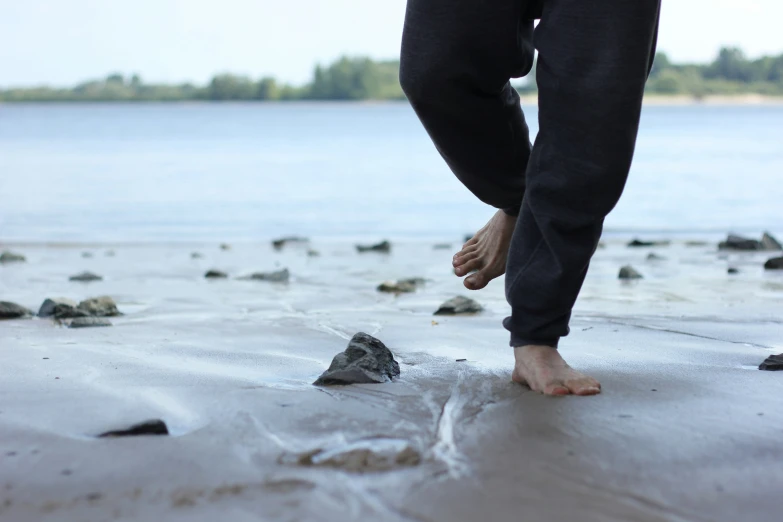 someone walking on a beach with low water