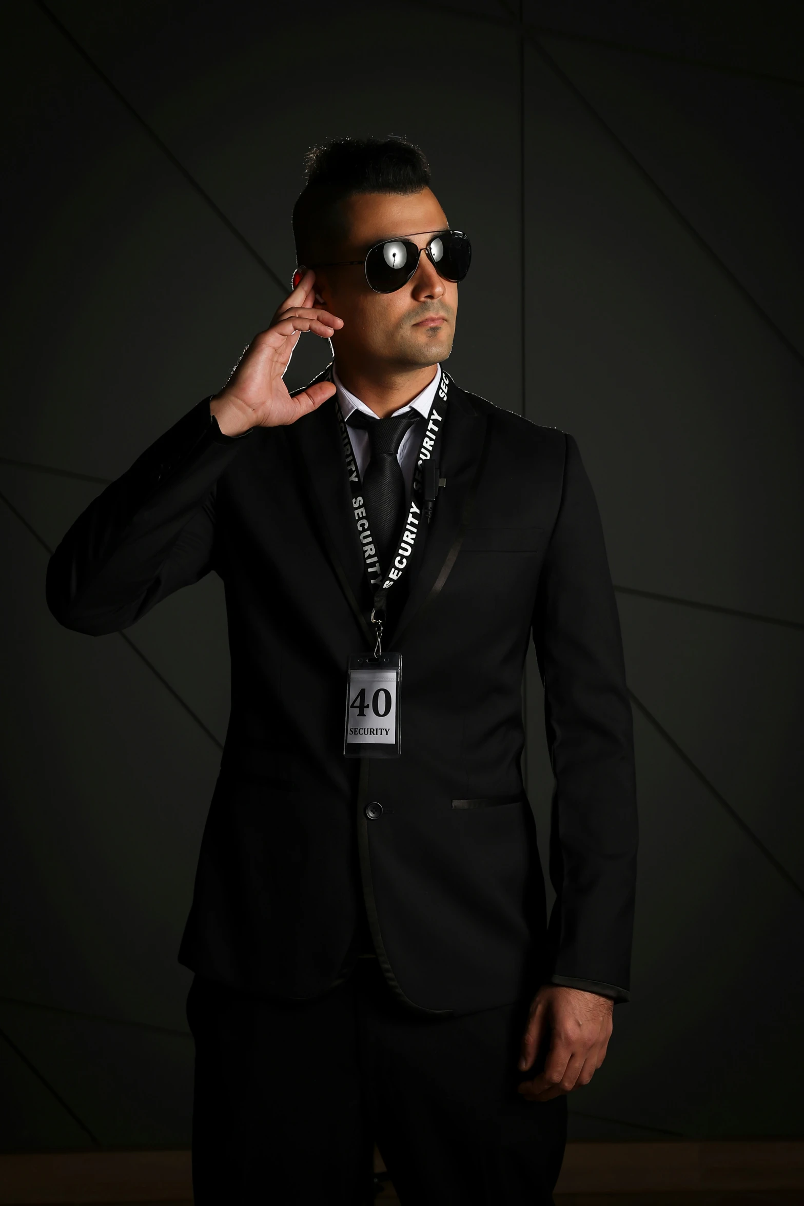 man in black with sunglasses poses for a camera