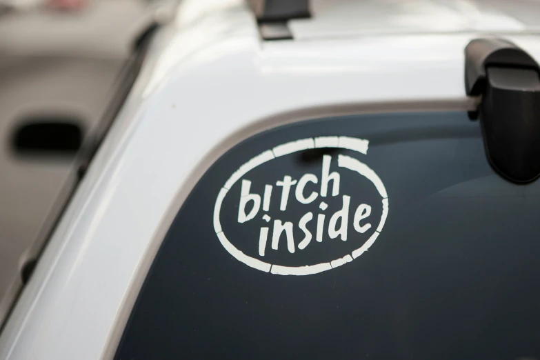 sticker of a white vehicle saying bitch inside