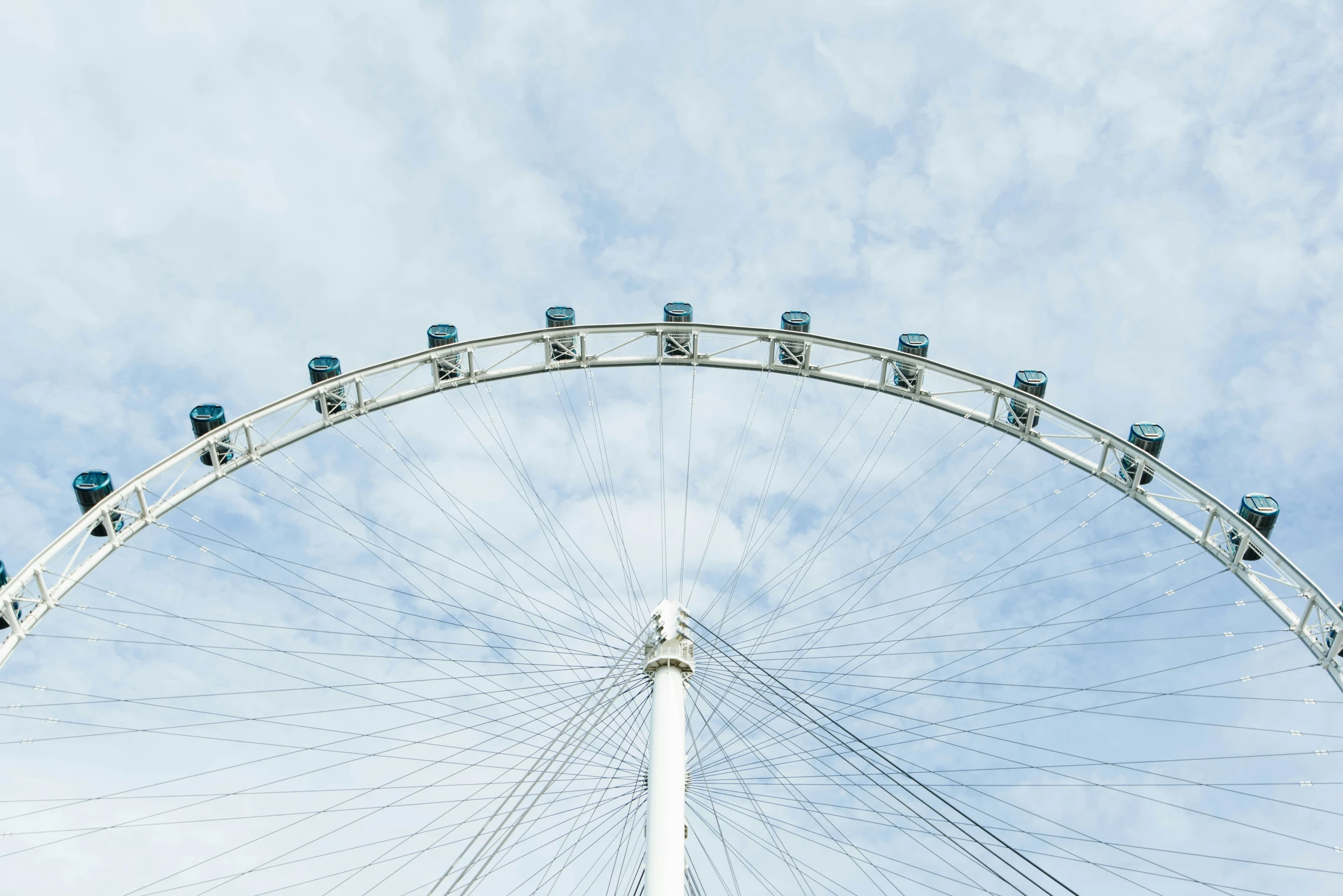 a large ferris wheel in front of some blue skies