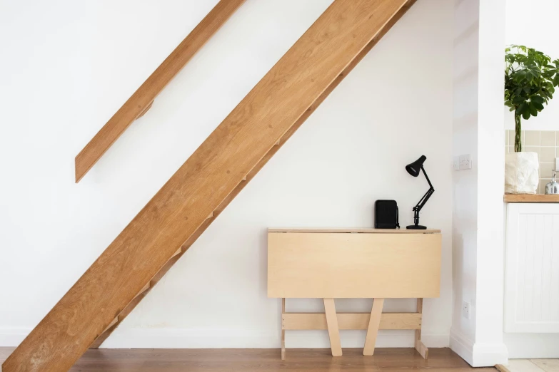 an open attic space with a desk and ladder