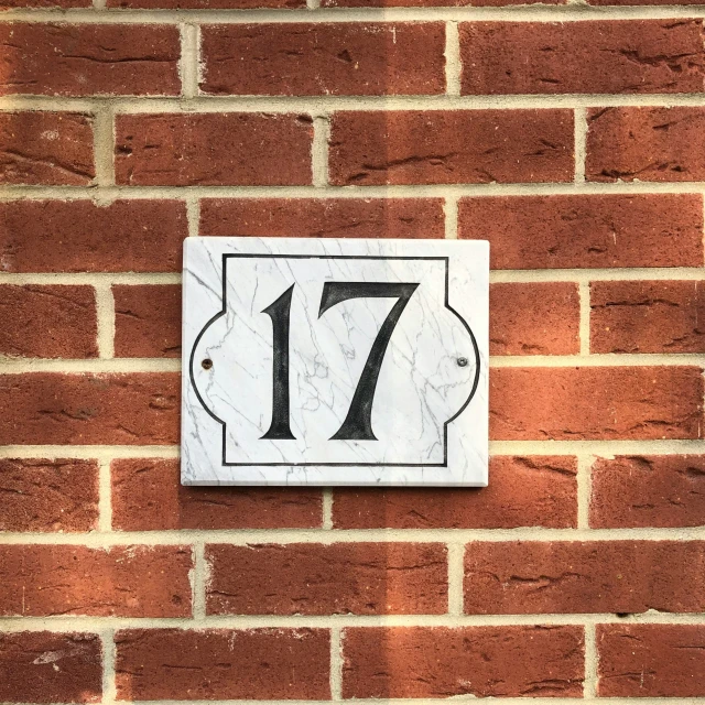 a close up of a sign on a brick wall