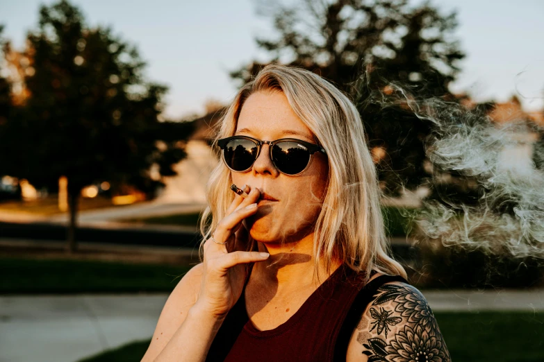 a woman smoking a cigarette next to the street