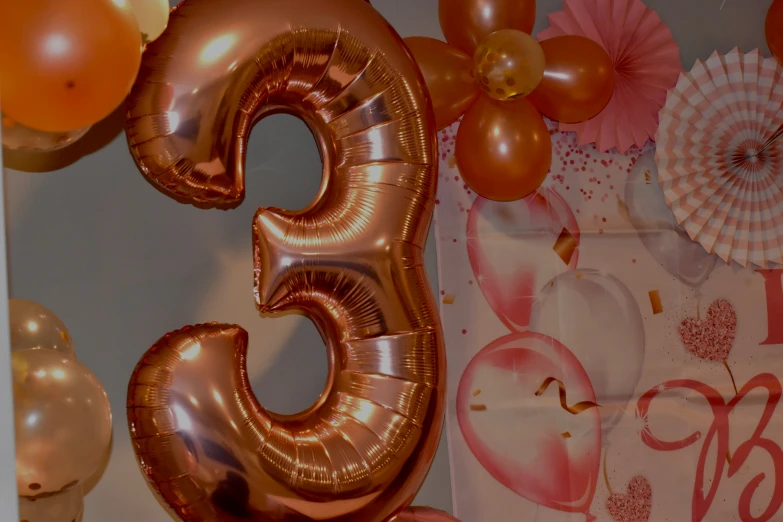 the number two balloon surrounded by helium balloons