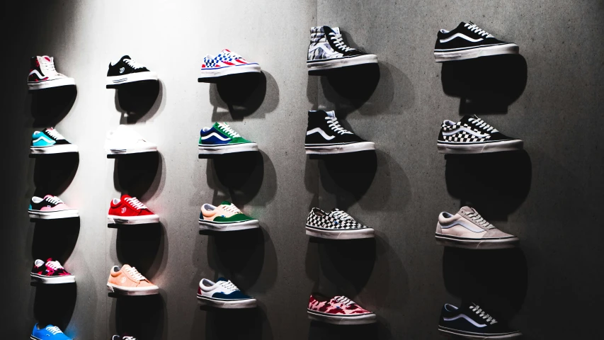 many sneakers are displayed on wall in a room