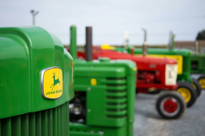 a line of tractors in a parking lot