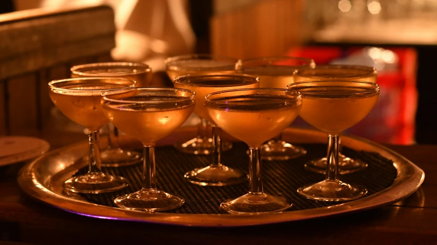 a tray holds wine glasses and empty one