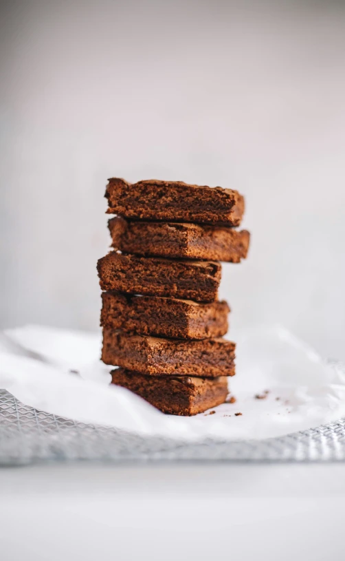 four slices of brownie on a towel stacked up