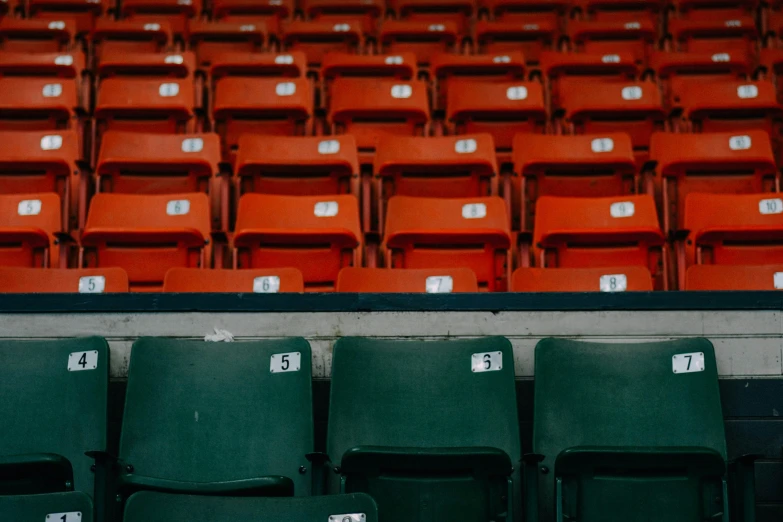 many orange and black seats in a stadium