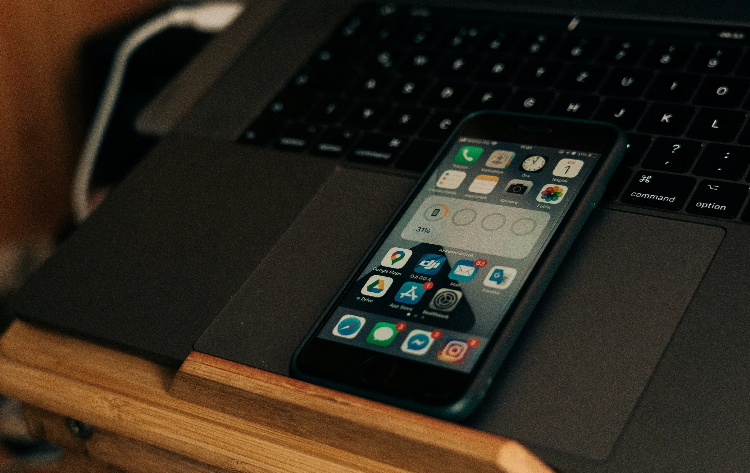 an iphone is sitting on the edge of a desk