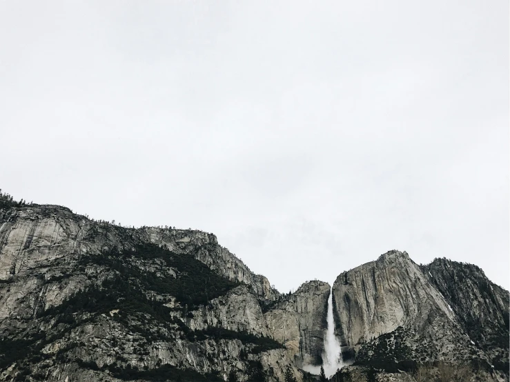 a large waterfall is shown on the side of a mountain