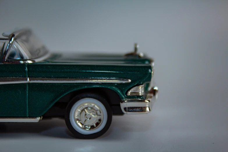 a small toy car with a metal rim sitting on top of a table