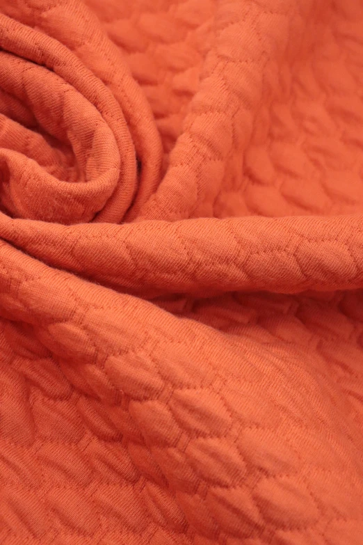 an orange piece of material that is very wrinkled