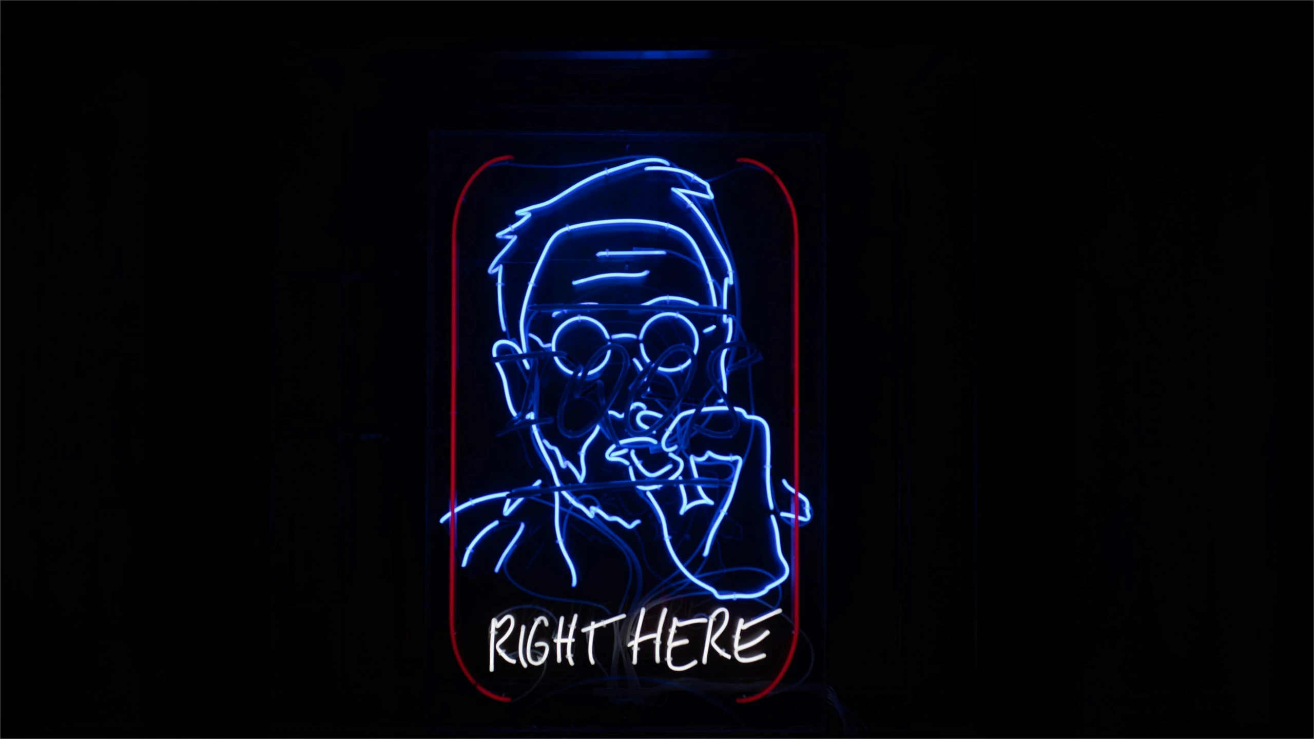 a neon sign is lit in the dark