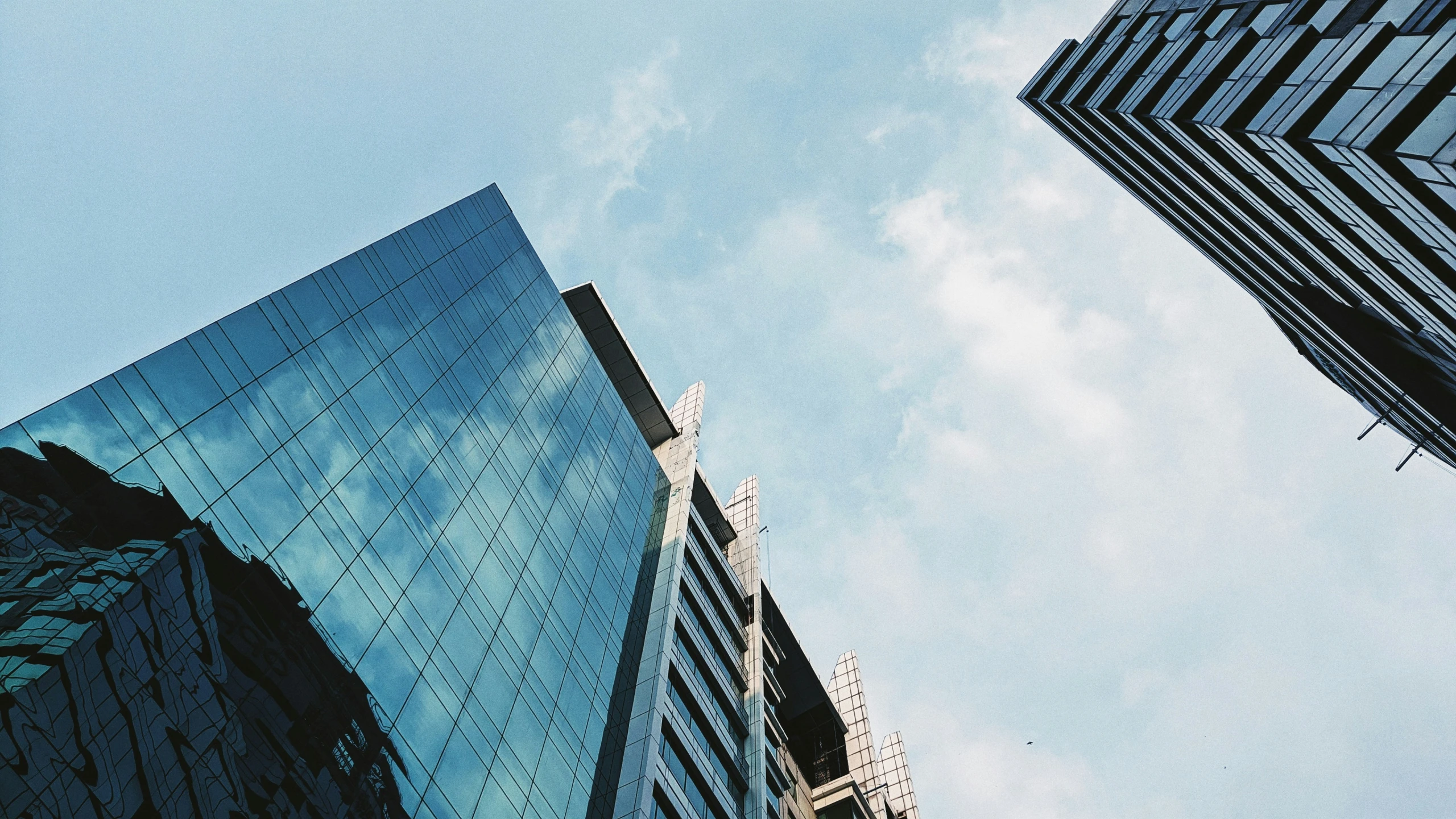 some very tall buildings in a city with blue sky