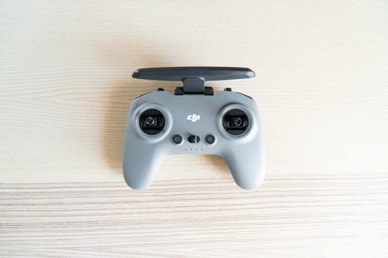 the front of a game controller is shown on a wooden surface