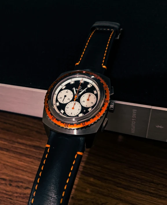 a watch with some black and orange detailing is pictured