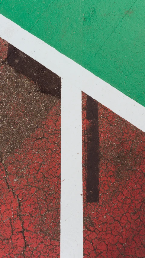 view down at the street showing a white double decker bridge in the middle of red and green paint