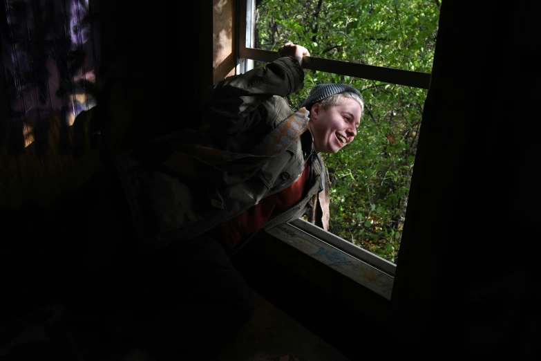 a child leans in the window looking out the outside