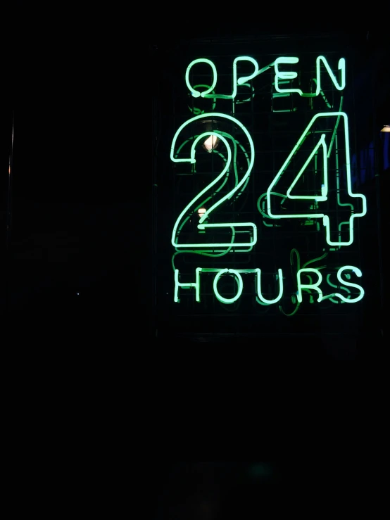 a black clock and neon sign with green numbers