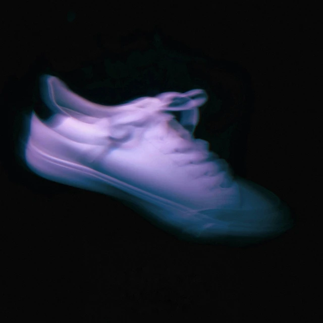 blue shoe lit by a pair of shoes flashed with light