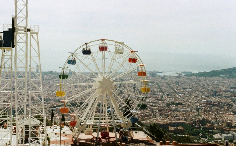 a ferris wheel in an amut park looking at the city