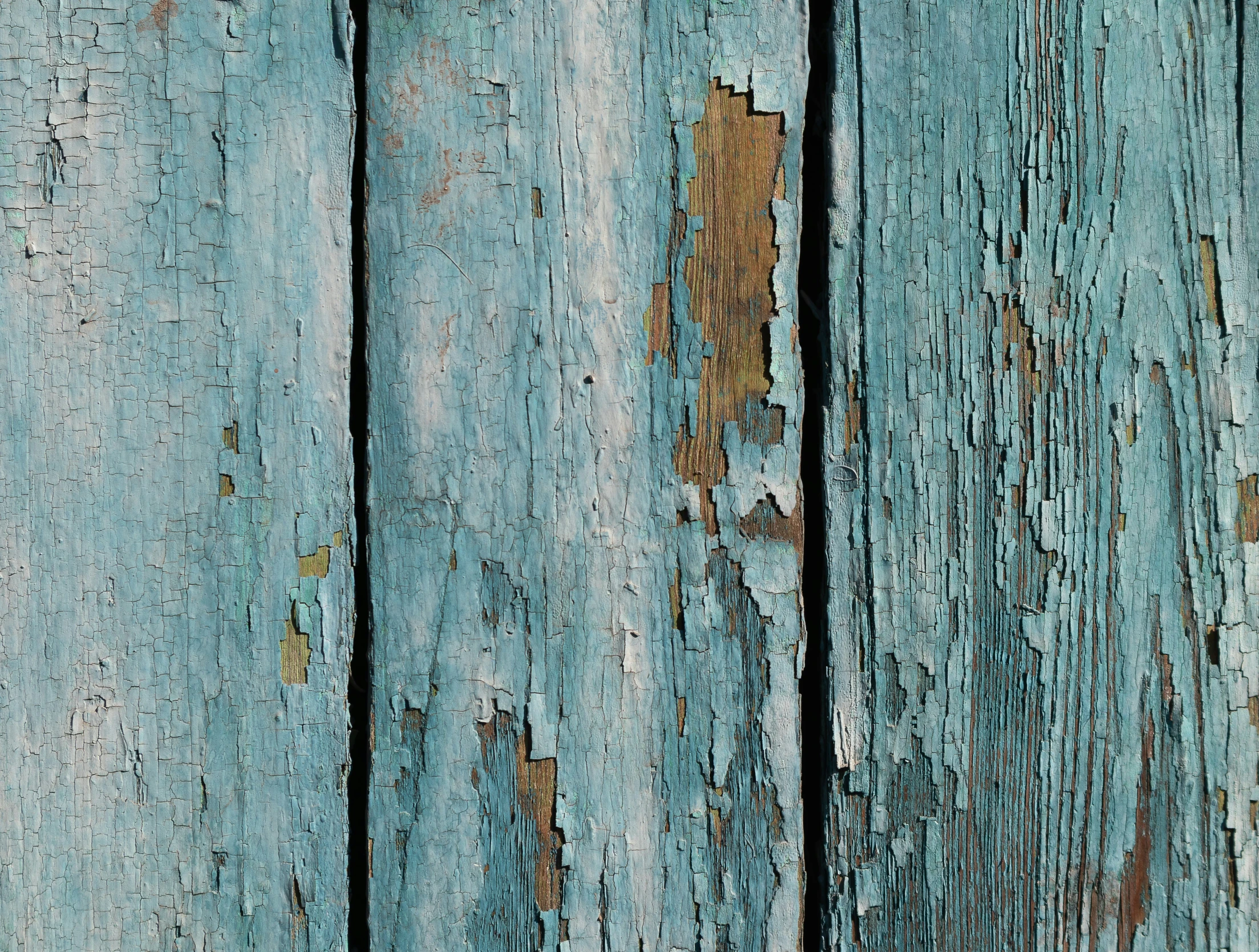 a very old blue weathered wood surface with only one piece missing