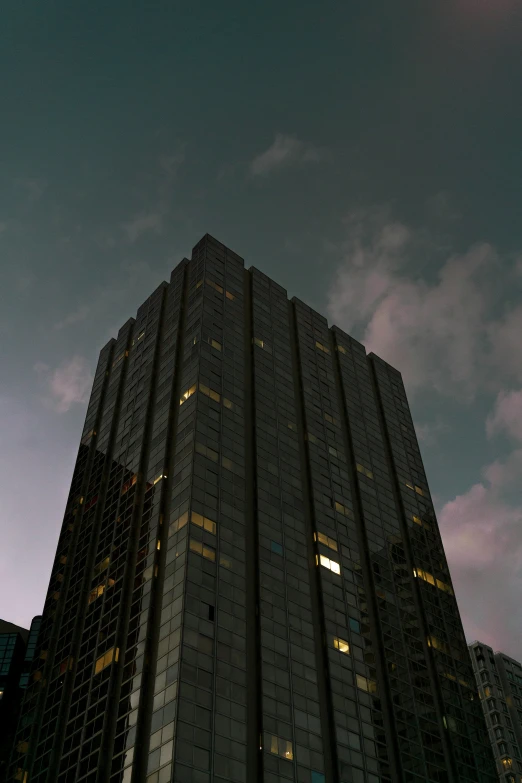 the sky is very dark in this view of the office building