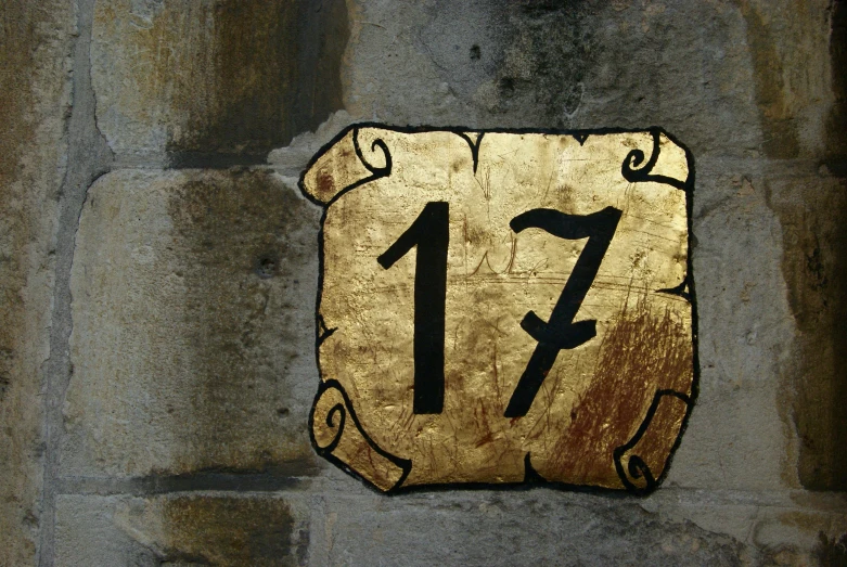 a sign on the side of a brick building says 17