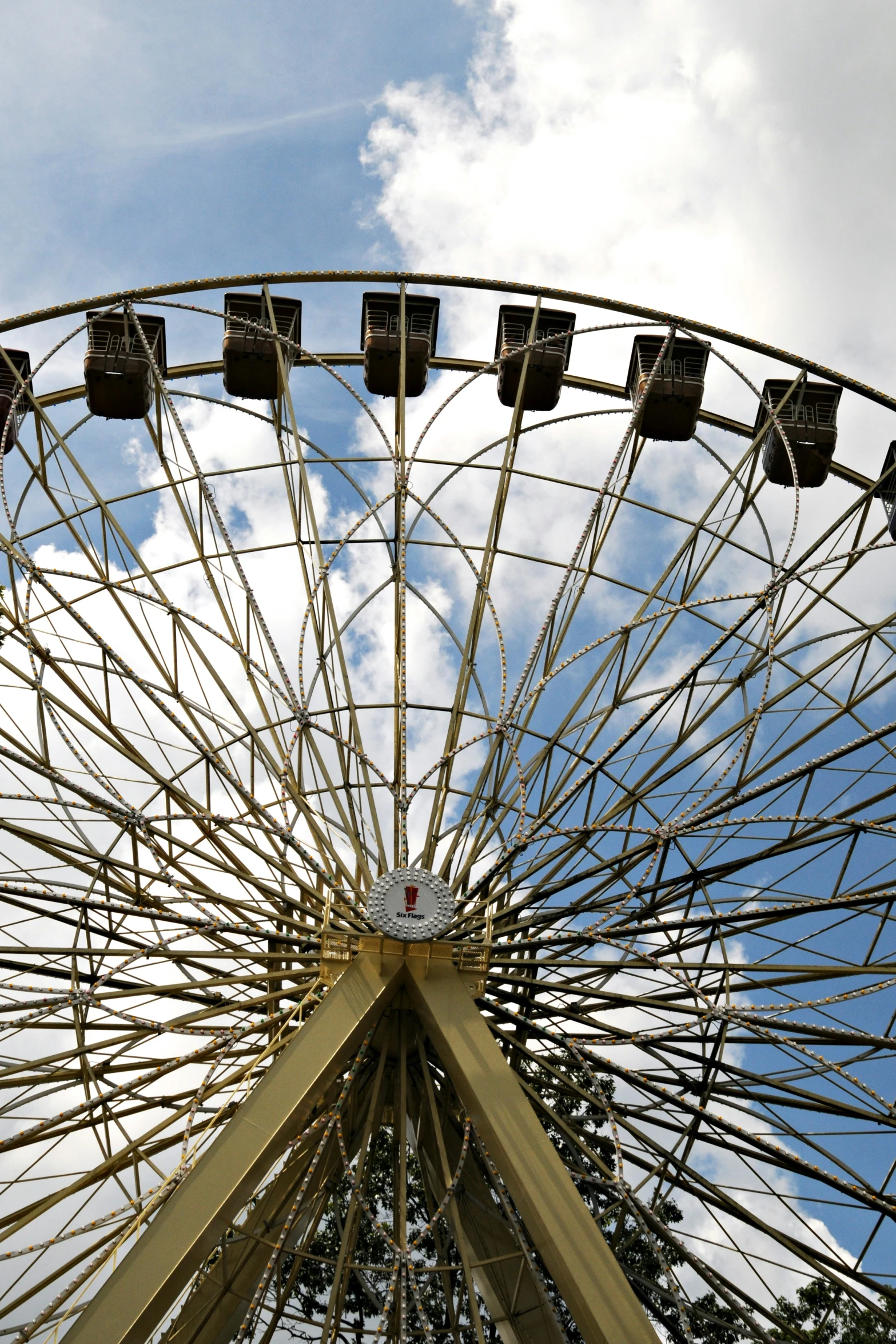 an amut park ferris wheel under a cloudy sky