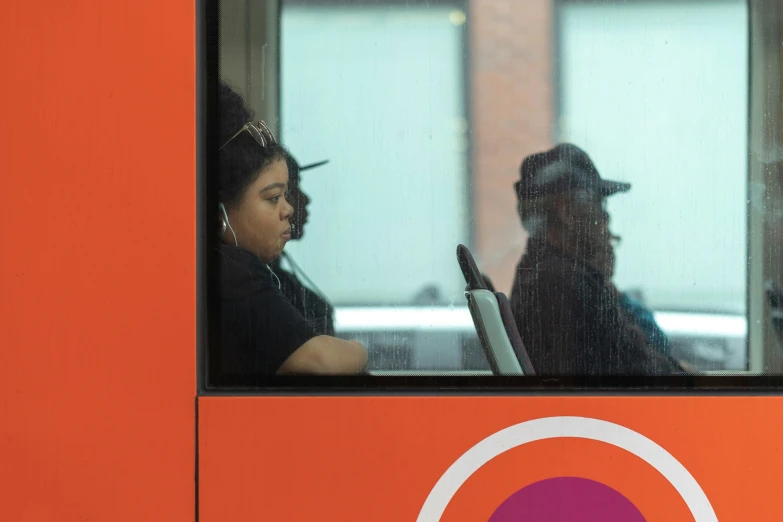 people sit on a bus in the day time