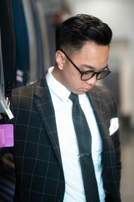 a man in glasses wearing a suit and tie