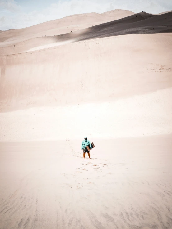 a person standing in the desert on a surfboard