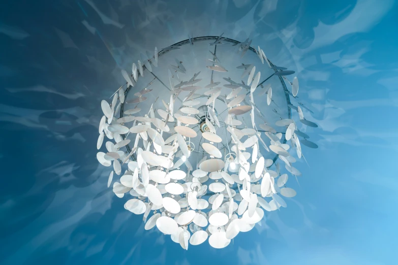 a very large lamp shade made of petals