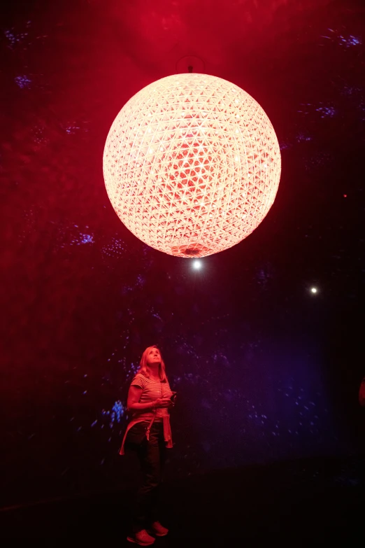 a lit up ball on a dimly lit stage