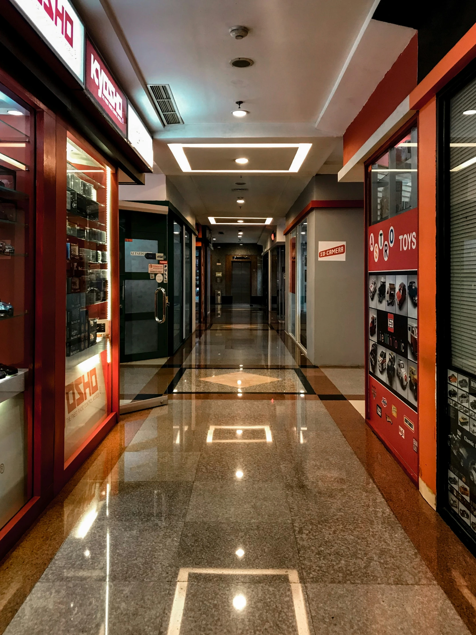 an empty hallway with a couple signs on the walls