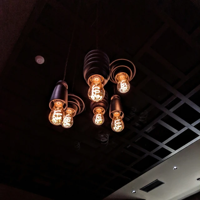 five chandeliers lit up in a room