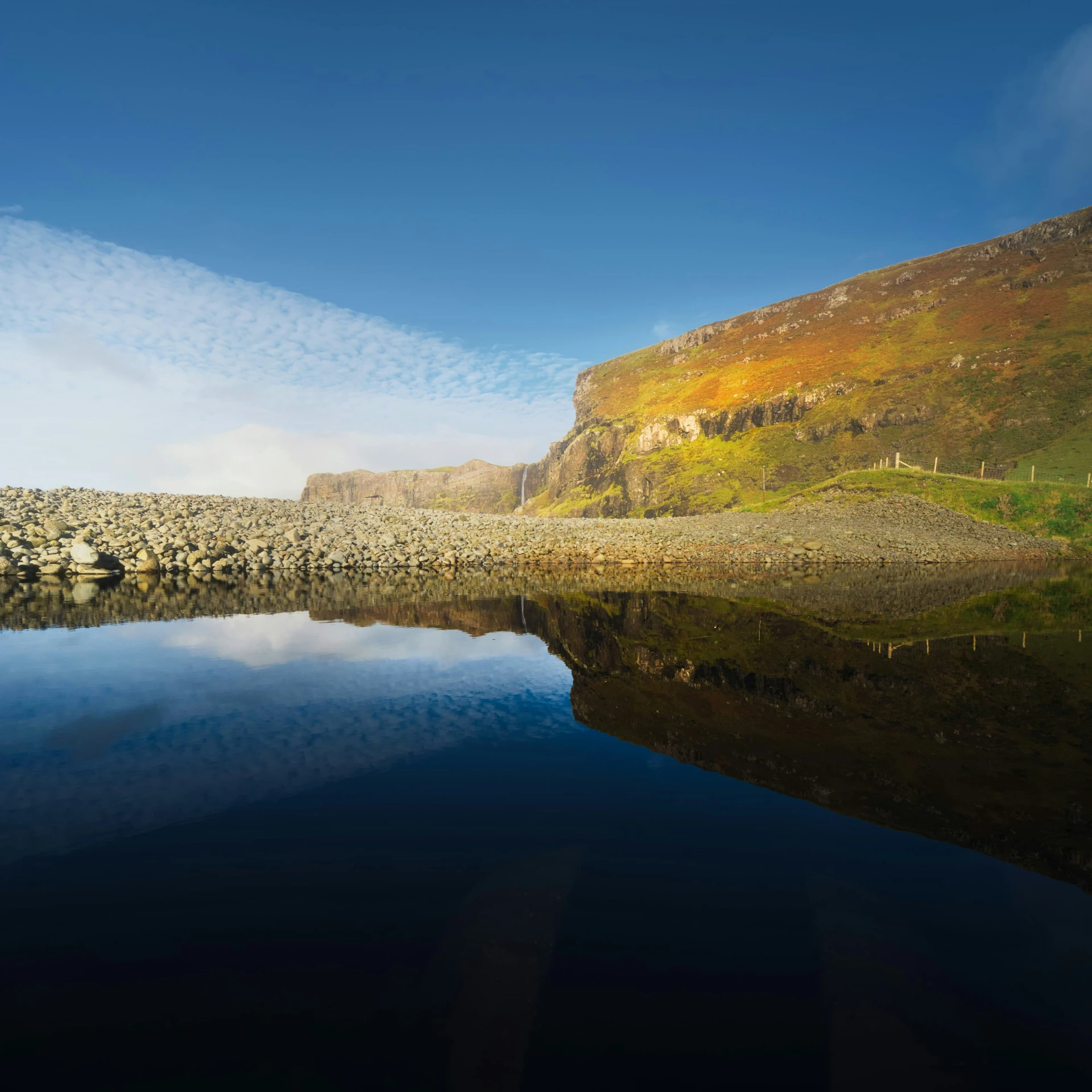 a large body of water with a few rocks on it