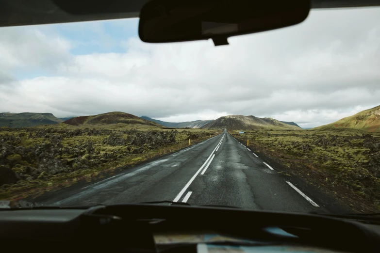 the view out a windshield of a small road