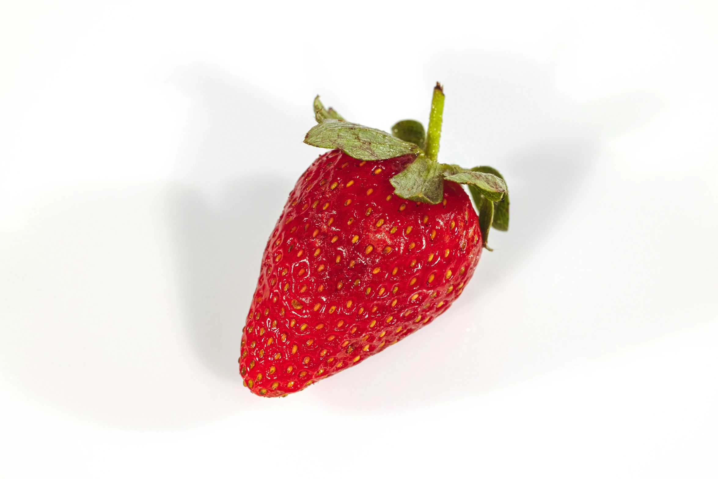 the small strawberry is in the white background