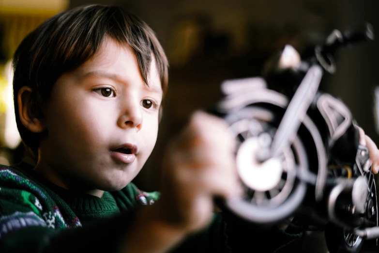 a  plays with his motorcycle engine