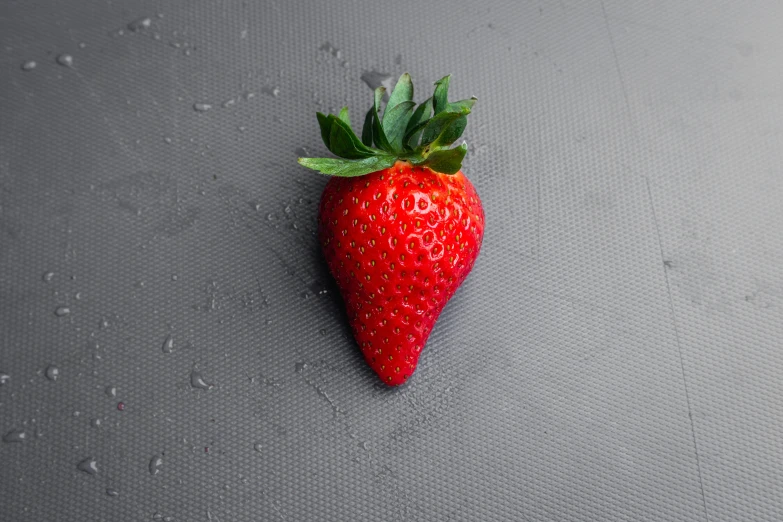 a small strawberry with a stalk attached to the end