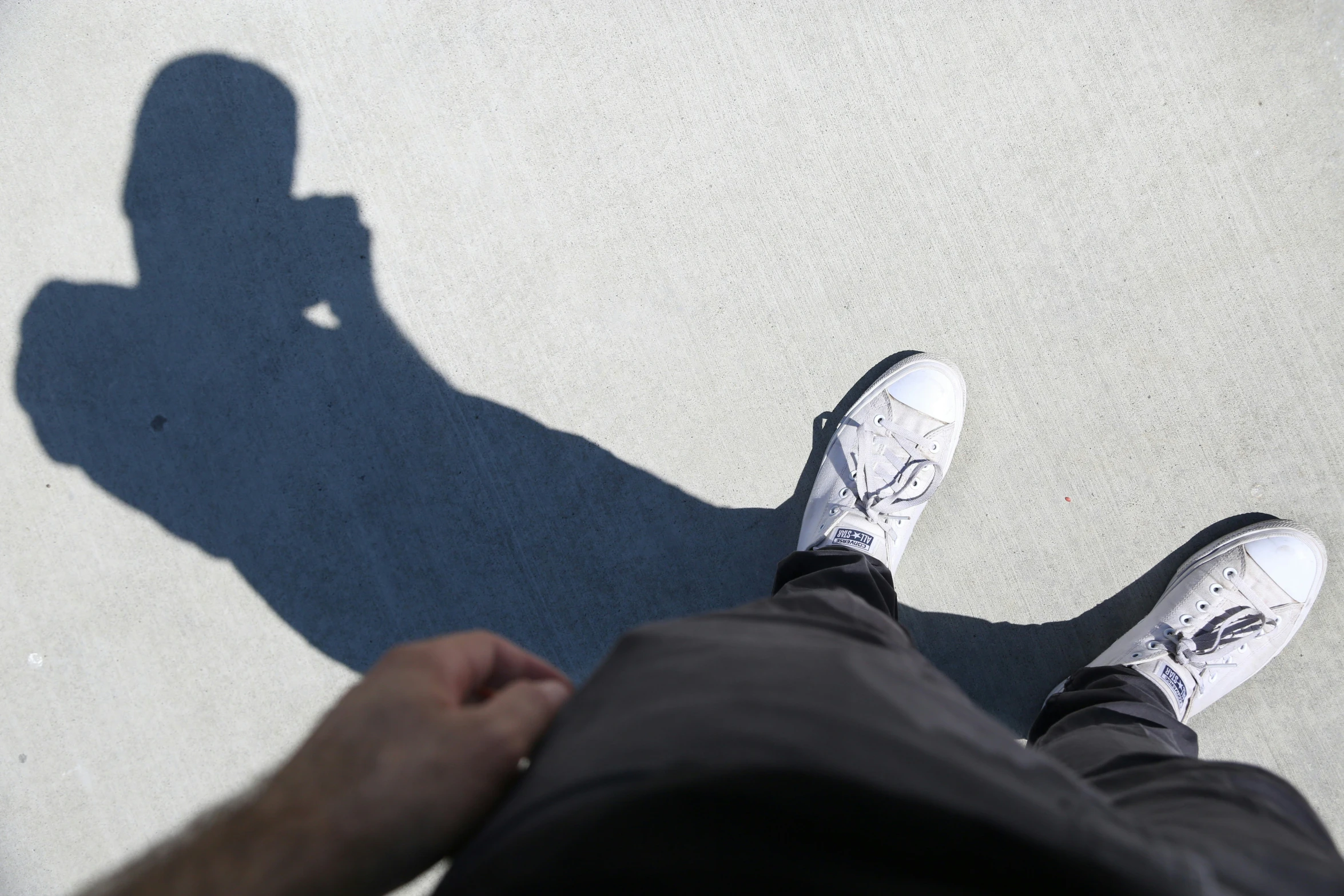 a person with white shoes standing next to another person