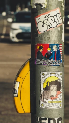 a bunch of stickers all over the sides of a pole