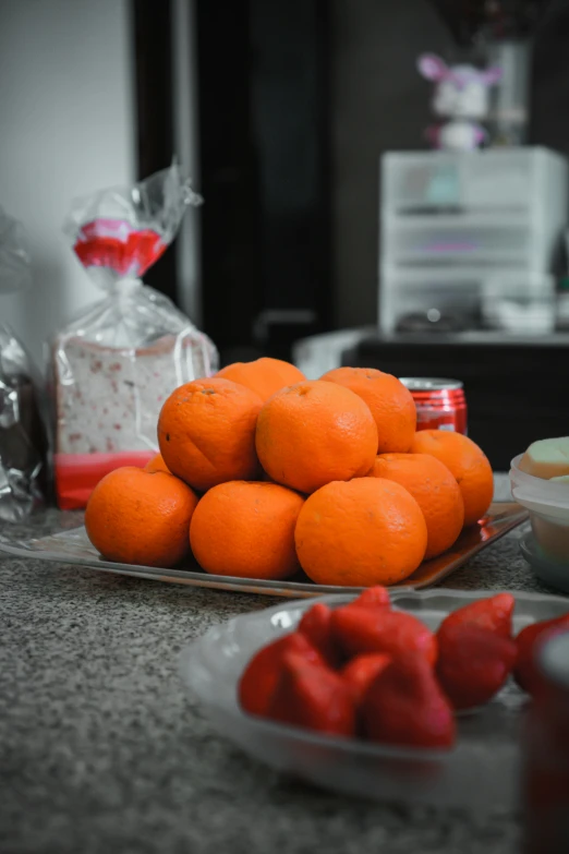 a bowl of oranges sitting on top of a table