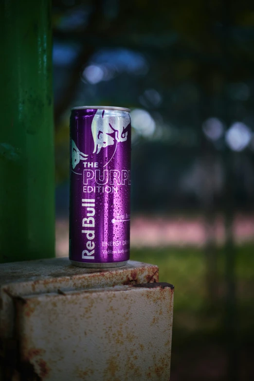 a close up of a can of beer on a block