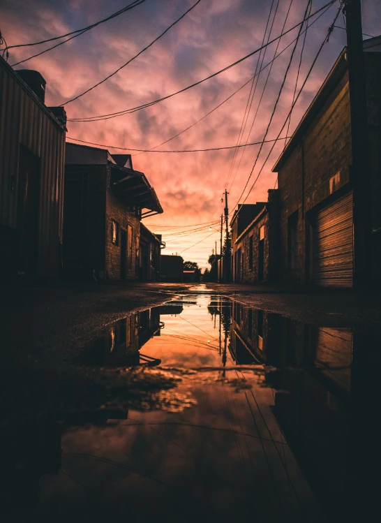 the setting sun as seen from a flooded alley