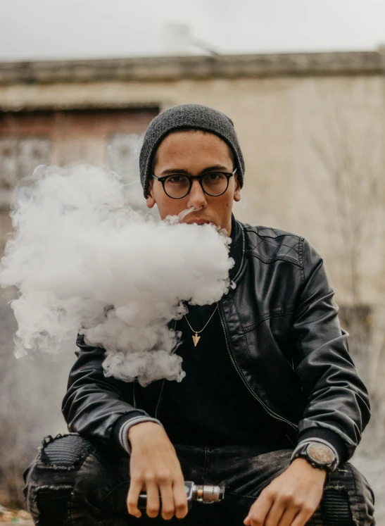 an image of a man smoking an electronic cigarette